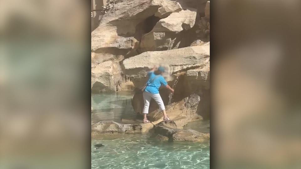 A tourist walked across the Trevi Fountain in Rome, Italy to fill up her water bottle before being escorted away by police.