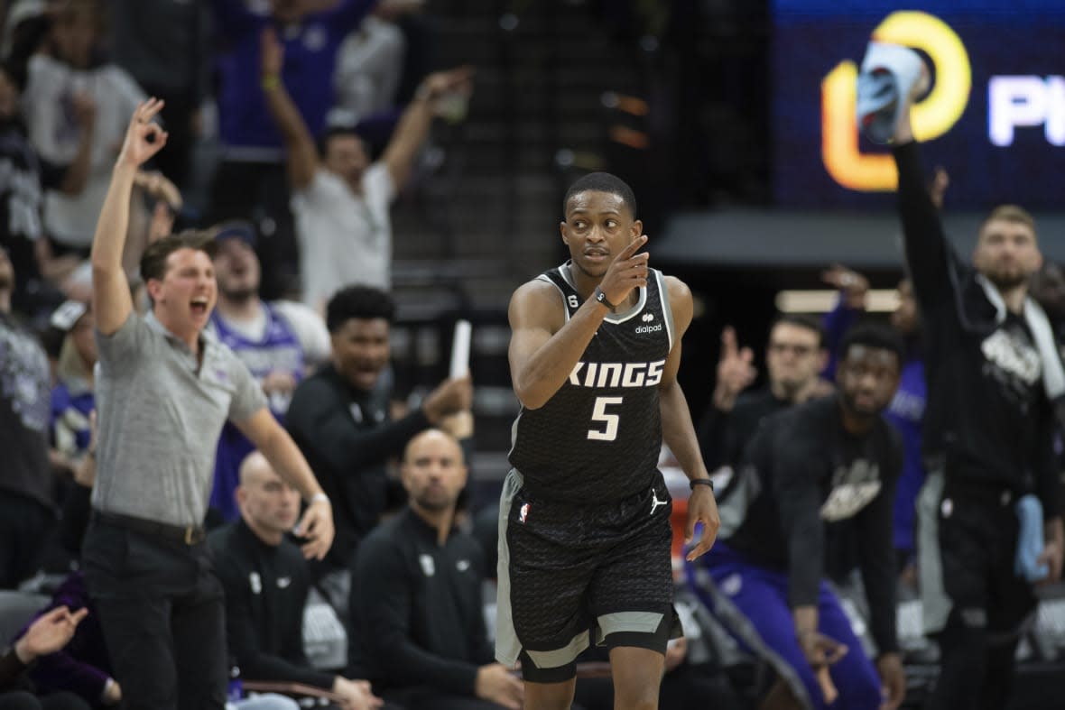 Sacramento Kings guard De’Aaron Fox (5) reacts after making a 3-point basket in the third quarter during Game 1 against the Golden State Warriors in the first round of the NBA basketball playoffs in Sacramento, Calif., Saturday, April 15, 2023. The Kings won 126 – 123. (AP Photo/José Luis Villegas)