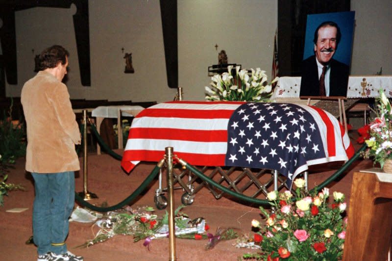 A mourner pays his last respects to the flag-draped casket of entertainer and politician Sonny Bono during a public vigil Janaury 8, 1998, at St. Theresa's Catholic Church in Palm Springs, Calif. Bono was killed in a skiing accident on January 5, 1998. File Photo by Jim Ruymen/UPI