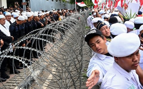 Protestors stage a demonstration in support of Prabowo Subianto - Credit: Goh Chai Hin/AFP