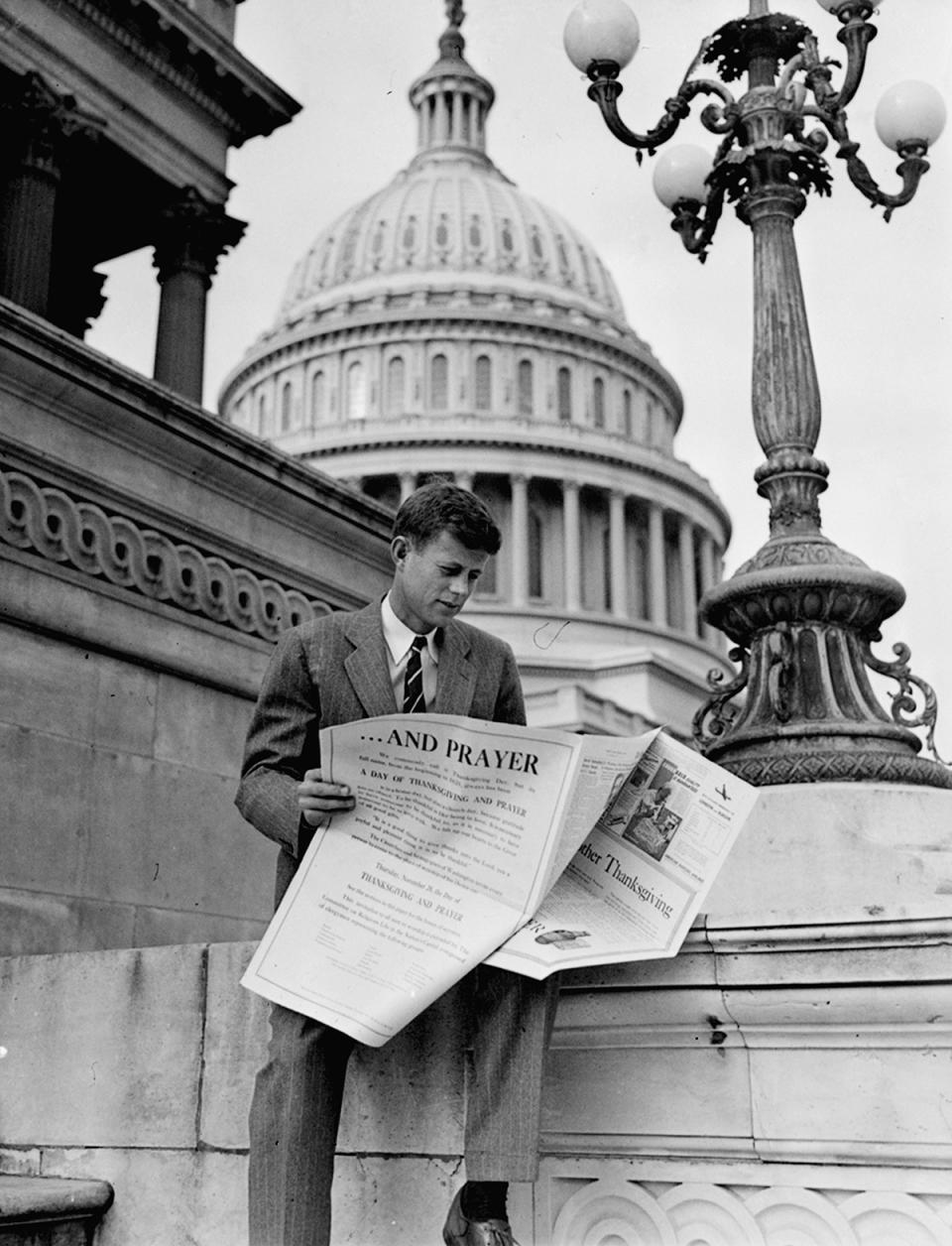 <p>Rep. John F. Kennedy, D-Mass., is shown looking through newspaper real estate ads on Capitol Hill in Washington, Nov. 27, 1946. (Photo: AP) </p>