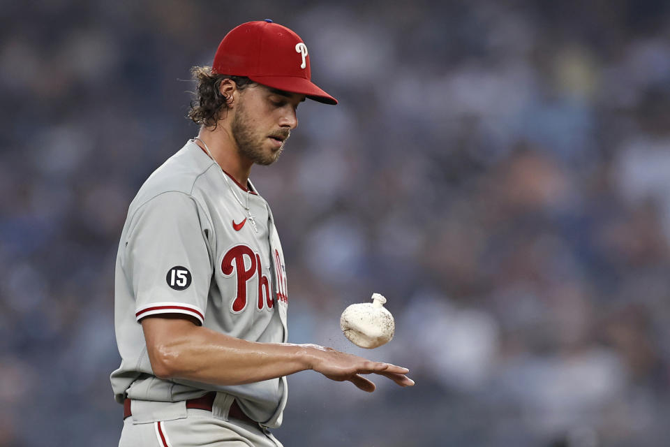 Philadelphia Phillies pitcher Aaron Nola tosses a rosin bag during the third inning of the team's baseball game against the New York Yankees on Tuesday, July 20, 2021, in New York. (AP Photo/Adam Hunger)