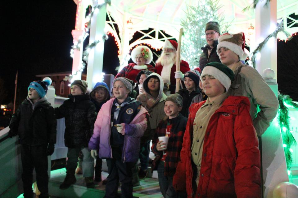 Cub Scouts 126 take a photo with Santa and Mrs. Claus during the Yule Log Christmas Celebration.