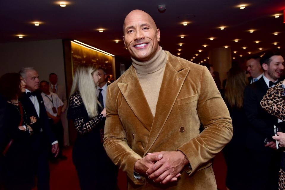 Dwayne Johnson smiling at an award ceremony