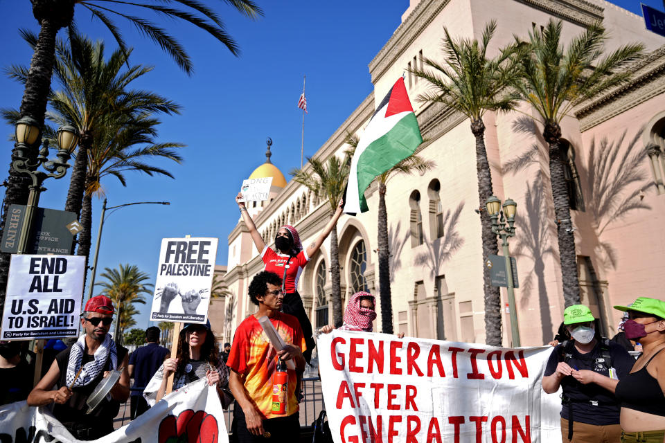 Pro-Palestinian demonstrators rally at the Shrine Auditorium where a commencement ceremony for graduates from Pomona College was being held Sunday, May 12, 2024, in Los Angeles. (AP Photo/Ryan Sun)