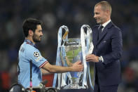 FILE - UEFA president Aleksander Ceferin hands the trophy to Manchester City's team captain Ilkay Gundogan after the the Champions League final soccer match between Manchester City and Inter Milan in Istanbul, Turkey, Sunday, June 11, 2023. The European Union’s top court has ruled UEFA and FIFA acted contrary to EU competition law by blocking plans for the breakaway Super League. The case was heard last year at the Court of Justice after Super League failed at launch in April 2021. UEFA President Aleksander Ceferin called the club leaders “snakes” and “liars.” (AP Photo/Francisco Seco, File)