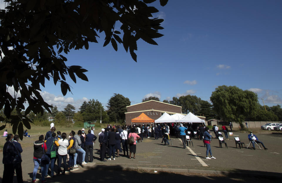 FILE — In this Friday, March 26, 2021 file photo, healthcare workers queue to receive a dose of Johnson & Johnson COVID-19 vaccine at a vaccination centre at Chris Hani Baragwanath Academic Hospital in Johannesburg, South Africa. In a television address to the nation Tuesday, March 30, 2021, Presidential Cyril Ramaphosa outlined the progress and the future of the COVID-19 vaccine rollout and put in place some minor restrictions for the Easter weekend. (AP Photo/Themba Hadebe, file)