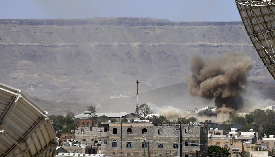 FILE - In this Sept. 9, 2015 file photo, smoke rises after an airstrike by the Saudi-led coalition on an army base in Sanaa, Yemen. Yemen’s war began in September 2014, when the Houthis seized the capital Sanaa. Saudi Arabia, along with the United Arab Emirates and other countries, entered the war alongside Yemen’s internationally recognized government in March 2015. The war has killed some 130,000 people and driven the Arab world’s poorest country to the brink of famine. (AP Photo/Hani Mohammed)