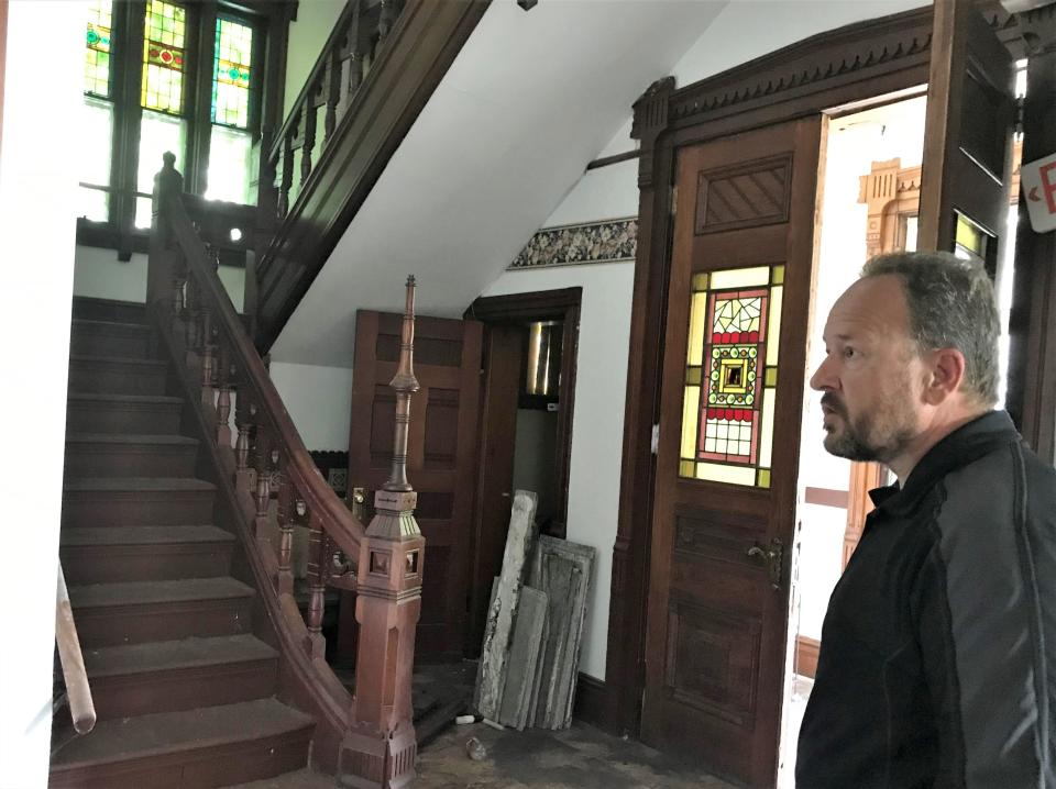 Real estate agent Mike Hamilton shows off the entryway to the Strawberry Mansion, 415 William St. in Elmira.