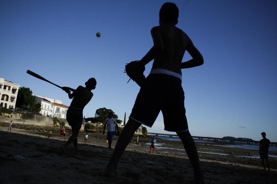 In this Oct. 15, 2018 photo, children play baseball on the beach during low tide in the Casco Viejo neighborhood of Panama City. (AP Photo/Arnulfo Franco)