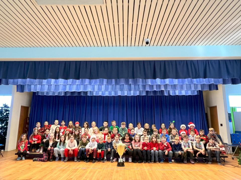 Students from Reverend George A. Brown Memorial School show off the Stuff the Stocking trophy after collecting more than 1,300 toys for the 2023 Season of Hope Toy Drive organized by Project Self-Sufficiency.