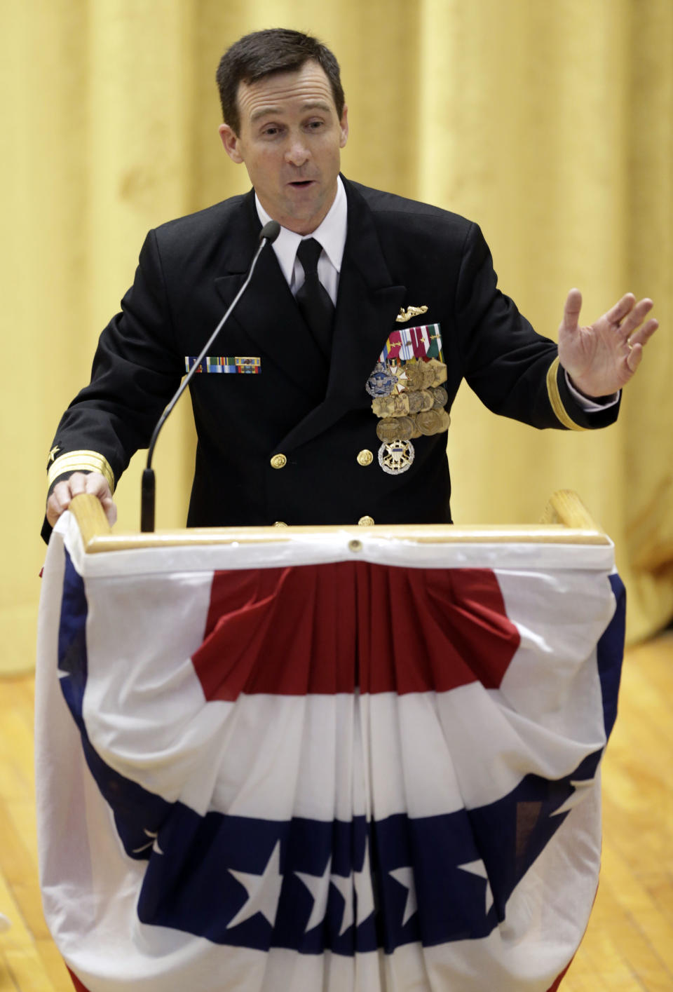 Rear Admiral Ken Perry speaks at the decommissioning ceremony for the fire-damaged USS Miami nuclear submarine at the Portsmouth Naval Shipyard, Friday, March 28, 2014, in Kittery, Maine. Perry, commander of the submarine Group Two in Groton, Conn., where the sub was based, acknowledged the seriousness of the event, but told the crowd they were there to celebrate the submarine and its crew’s achievements. “This is a tribute. This is a celebration of the ship’s performance and the superb contributions to the nation’s defense and this is how we’re going to treat it. So I expect to see some smiles out there,” he said. (AP Photo/Robert F. Bukaty)