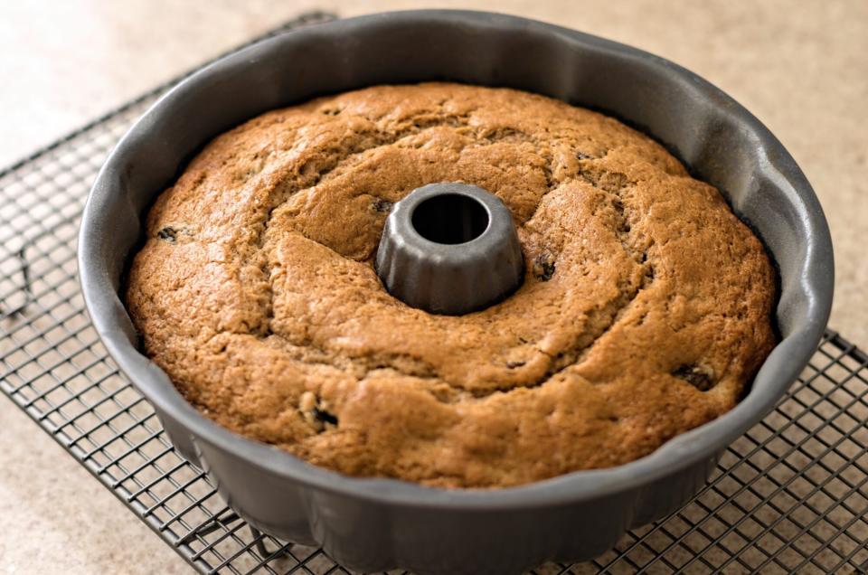 bundt cake in pan on cooling rack