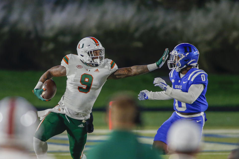 Miami tight end Brevin Jordan (9) stiff-arms a Duke defender. (Nell Redmond/Pool Photo via AP)