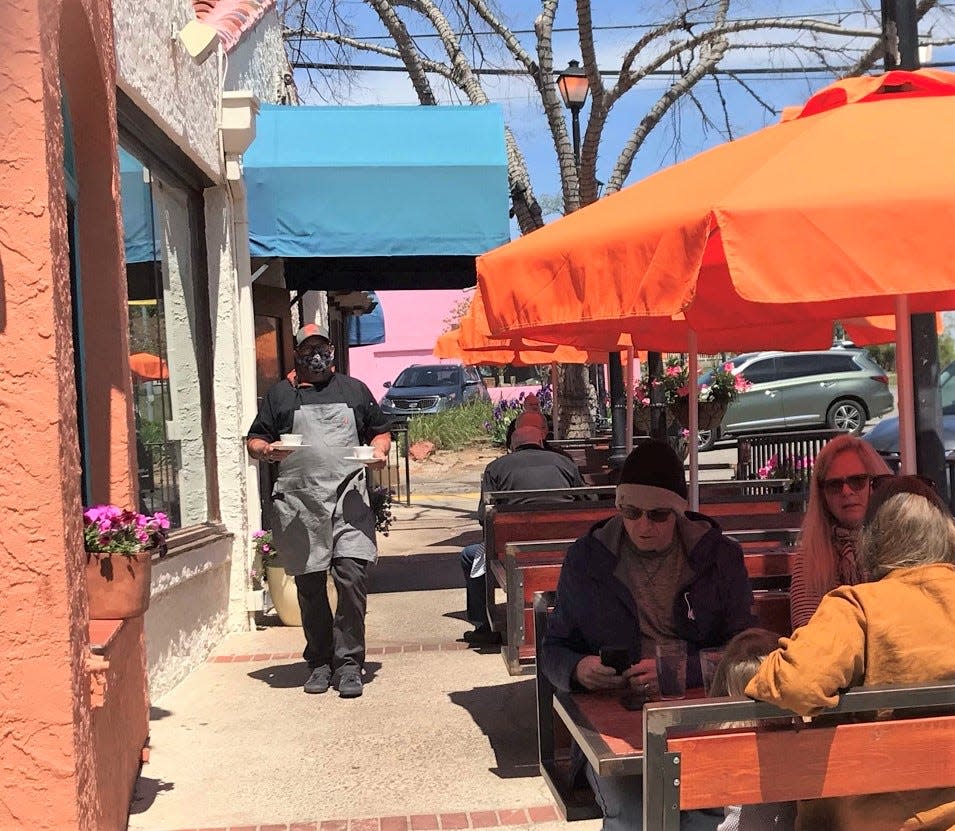 Chef Ryan Parrott walks food out to sidewalk diners at Picasso&#39;s Cafe in Oklahoma City&#39;s Paseo Arts Distric.