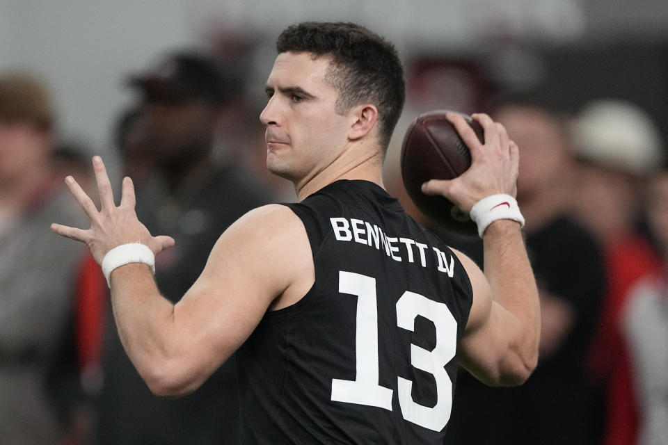 FILE - Former Georgia quarterback Stetson Bennett throws during drills at Georgia football Pro Day, Wednesday, March 15, 2023, in Athens, Ga. In the first nine drafts after former sixth-round pick Tom Brady won his first Super Bowl following the 2002 season, there were an average of seven QBs taken in the final three rounds of the draft. (AP Photo/John Bazemore, File)