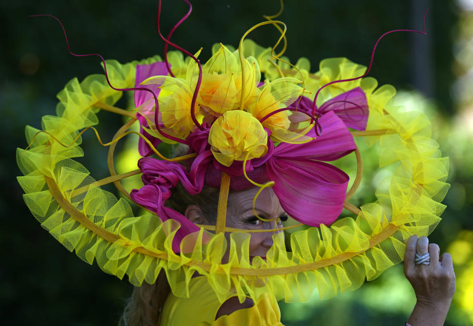 Racegoer Vivienne Jenner poses for a photo after arriving for day one of the Royal Ascot horse racing meeting, at Ascot Racecourse, in Ascot, England, Tuesday June 14, 2022. (AP Photo/Alastair Grant)