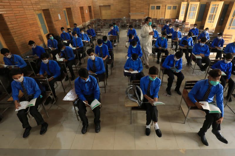 Students wear protective masks maintaining safe distance as they attend a class as schools reopen amid the coronavirus disease (COVID-19) pandemic, in Peshawar