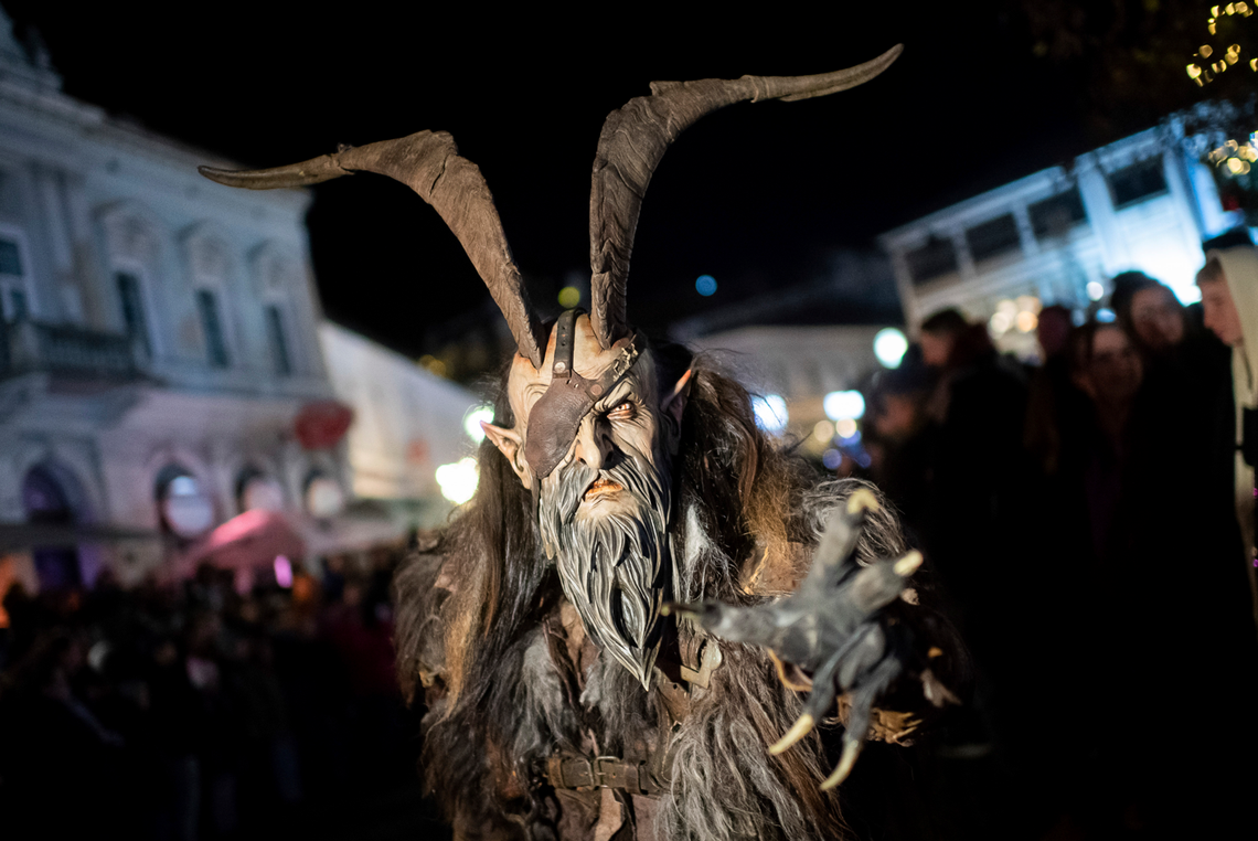 A participant wears a traditional Krampus costume and a mask during a Krampus run in Hollabrunn, Austria, Sunday, Nov. 26, 2022.