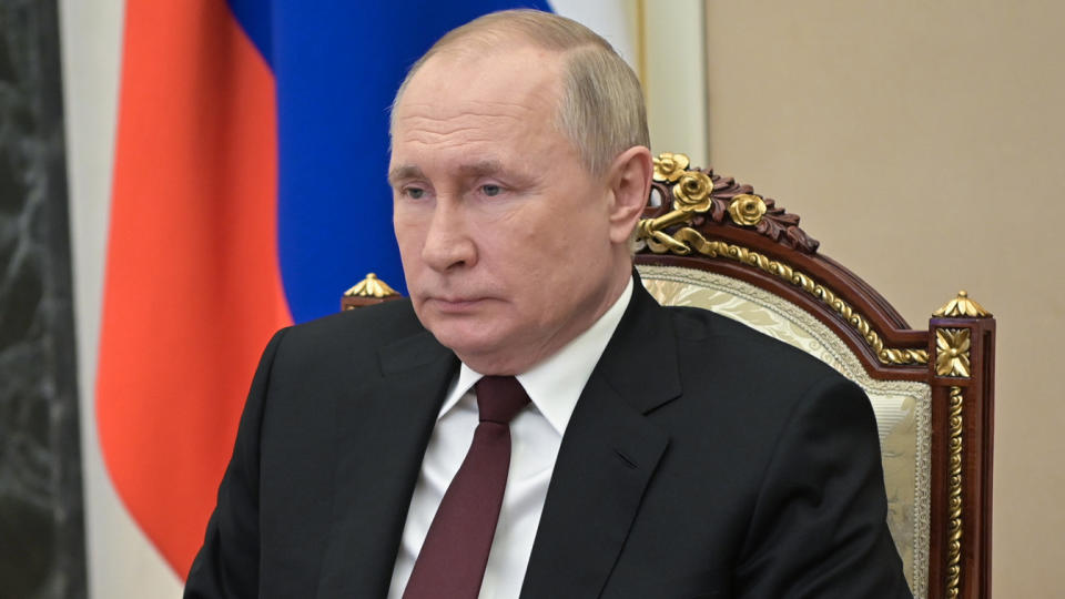 Russian President Vladimir Putin sits during a Russian Security Council video meeting. 