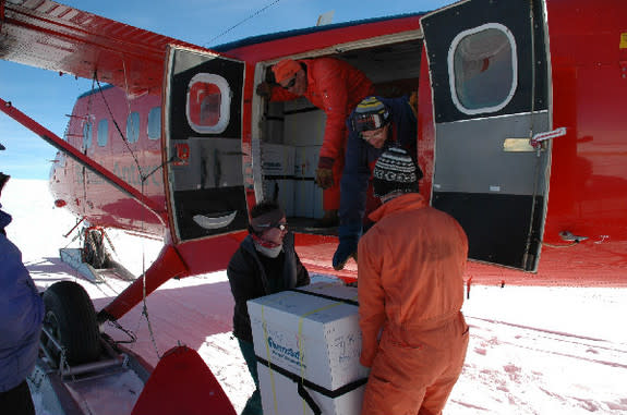 Researchers load boxes of ice cores onto an airplane. The ice cores, taken from James Ross Island near the Antarctic Peninsula, were used to reconstruct temperature history of the region and better understand the recent collapse of ice shelves.