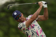 Rickie Fowler watches his tee shot on the 14th hole during a practice round for the PGA Championship golf tournament, Tuesday, May 17, 2022, in Tulsa, Okla. (AP Photo/Matt York)