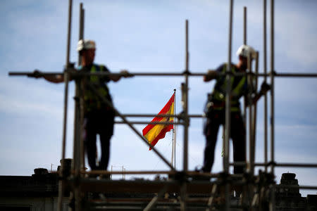 FILE PHOTO: Workers build a pipe structure on a scaffolding in Seville, Spain, April 28, 2016. REUTERS/Marcelo del Pozo/File Photo