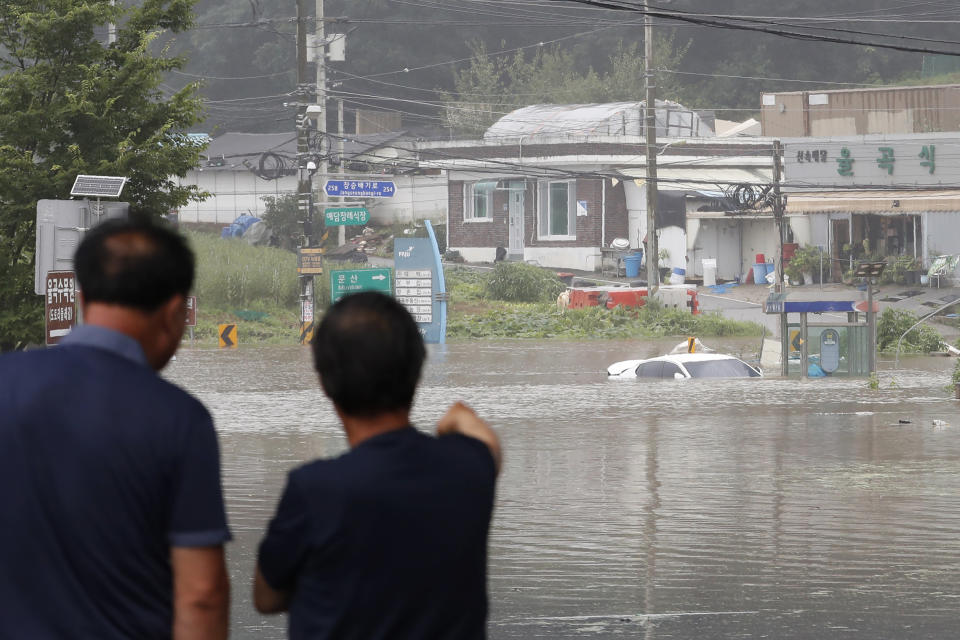 A vehicle is submerged in floodwaters following heavy rains in Paju, South Korea, Thursday, Aug. 6, 2020. Torrential rains continuously pounded South Korea on Thursday, prompting authorities to close parts of highways and issue a rare flood alert near a key river bridge in Seoul. (AP Photo/Ahn Young-joon)