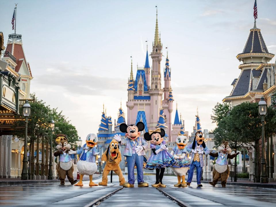 Chip, Dale, Donald, Pluto, Daisy, Mickey, Minnie, and Goofy wear 50th anniversary outfits at Magic Kingdom.