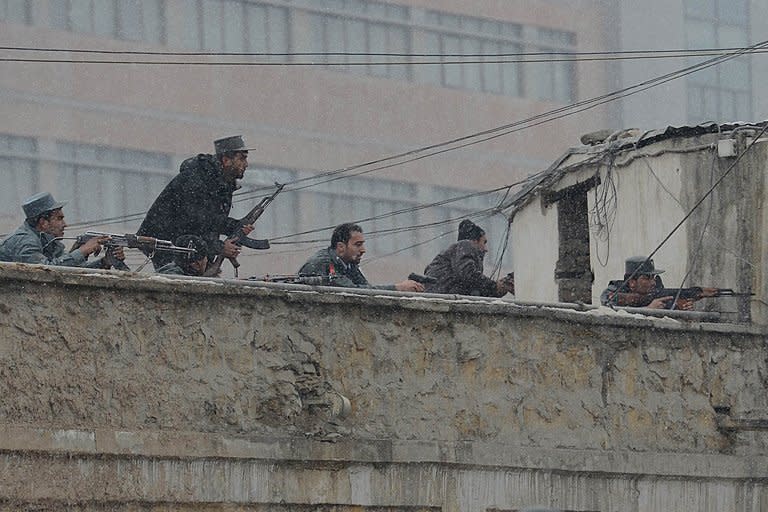 Afghan security forces exchange fire with militants at the site of a suicide attack near the Afghan intelligence agency headquarters in Kabul on January 16, 2013. A squad of suicide bombers attacked the Afghan intelligence agency headquarters in heavily-fortified central Kabul Wednesday, killing at least one guard and wounding dozens of civilians, officials said