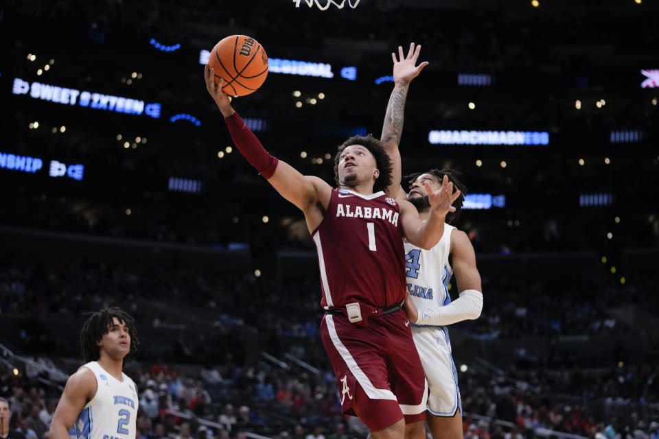 Alabama guard Mark Sears (1) drives past North Carolina guard RJ Davis (4) during the second half of a Sweet 16 college basketball game in the NCAA tournament Thursday, March 28, 2024, in Los Angeles. (AP Photo/Ashley Landis)