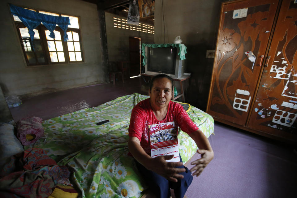 In this March 14, 2019, photo, Nuwate Jiamwong, 59-year-old farmer, talks to The Associated Press during an interview as the farmer holds a calendar with a picture of former Prime Minister Thaksin Shinawatra on it, in Nakhon Ratchasima, Thailand. Thailand’s former Prime Minister Thaksin Shinawatra is in exile and banned from interfering in the country’s politics. But his name is a powerful political attraction and in tribute, and to win votes, some candidates in general election on Sunday, March 24, 2019 have changed their names to Thaksin so supporters of the former leader can register their loyalty at the ballot box. "No matter what anyone said about him, I always loved him since many years ago," says the farmer. (AP Photo/Sakchai Lalit)