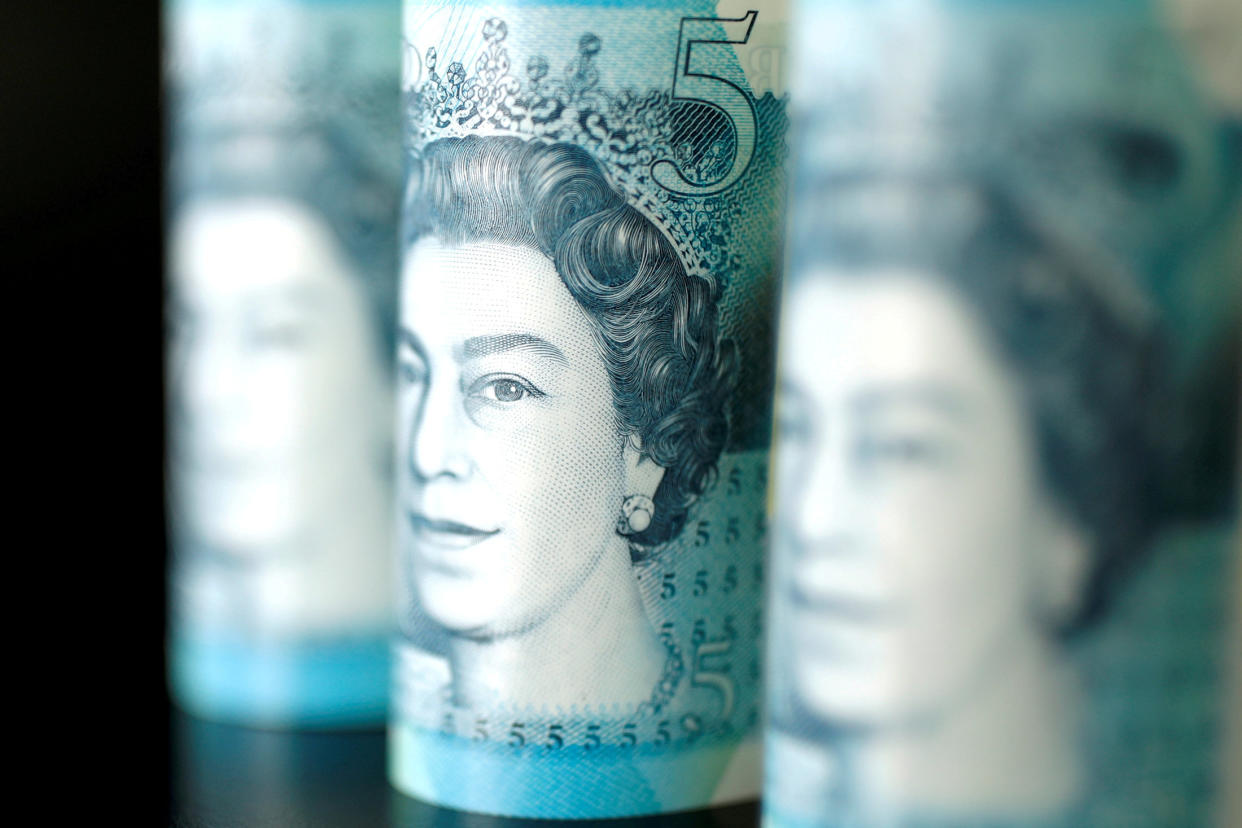 British five pound banknotes are seen in this picture illustration. Photo: REUTERS/ Benoit Tessier/File Photo