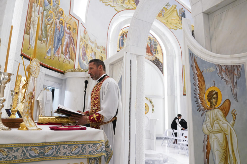 Father Andreas Vithoulkas participates in a service at St. Nicholas Greek Orthodox Church in New York, Tuesday, Dec. 6, 2022. After a rebuilding process that lasted more than two decades, the Greek Orthodox church that was destroyed in the Sept. 11 attacks has reopened at the World Trade Center site. The St. Nicholas Greek Orthodox Church and National Shrine, designed by architect Santiago Calatrava, now overlooks the Trade Center memorial pools from an elevated park. (AP Photo/Seth Wenig)