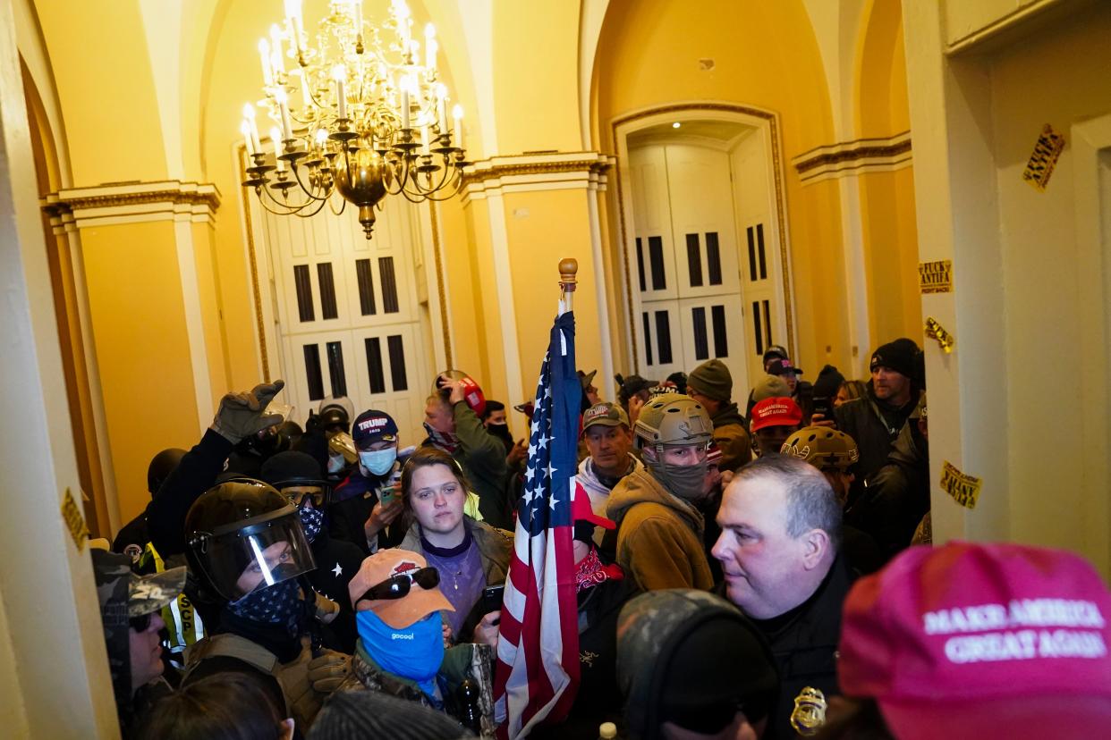 Supporters of President Donald Trump stand inside the U.S. Capitol on Wednesday, Jan. 6, 2021, in Washington.
