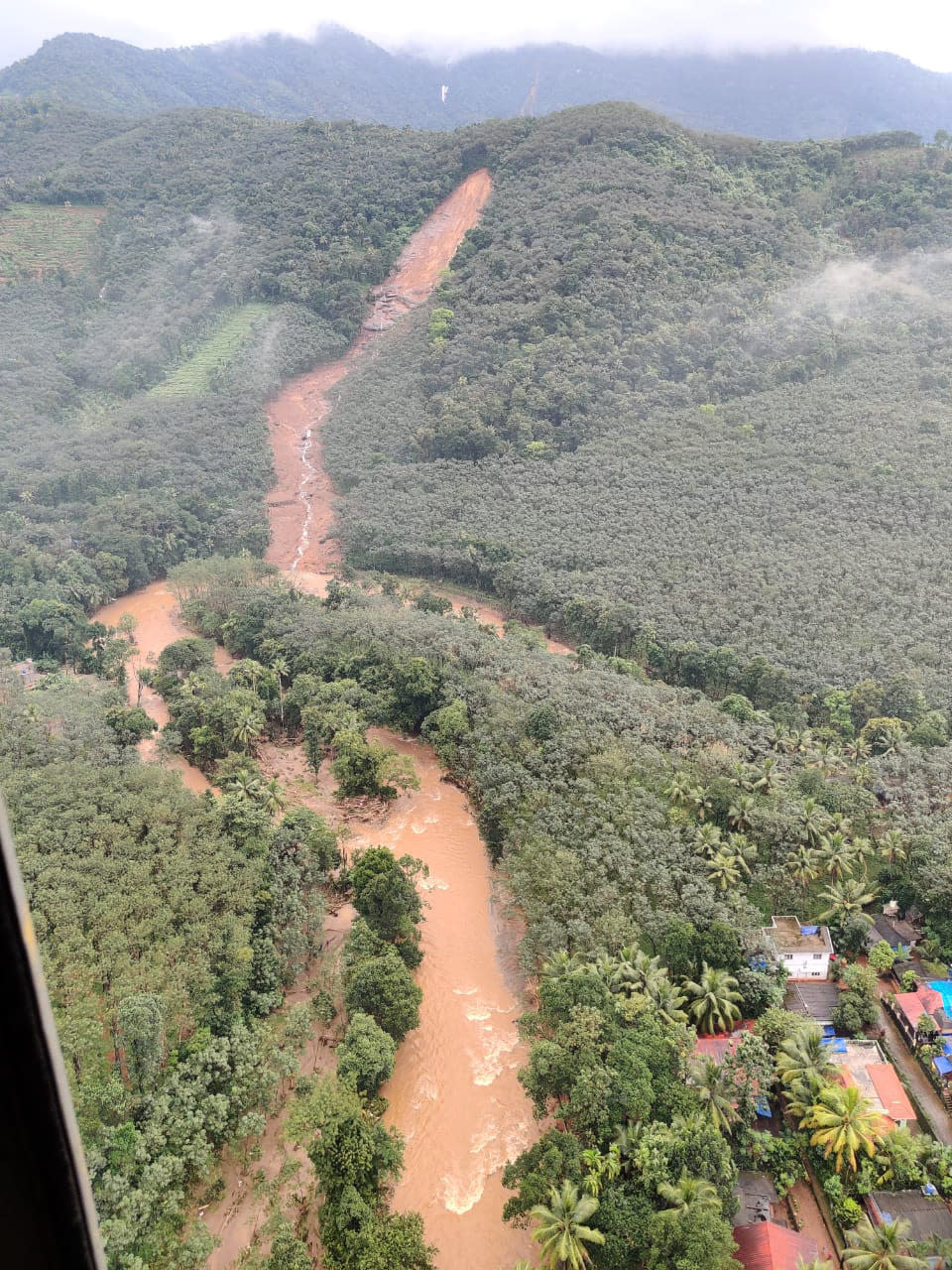 This photograph provided by the Indian Navy and taken from a naval helicopter shows the scene after a landslide triggered by heavy rains in the western ghats mountains at Koottickal in Kottayam district, southern Kerala state, India, Sunday, Oct.17, 2021. Bodies of six people have been recovered, and rescuers are searching for those feared missing. (Indian Navy via AP)