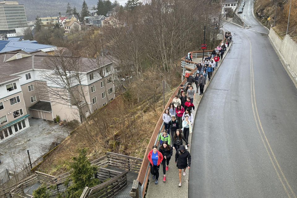 Students and supporters walk from Juneau-Douglas High School: Yadaa.at Kalé to the state Capitol, Thursday, April 4, 2024, in Juneau, Alaska. They marched to the Capitol as part of a student walkout to protest Republican Gov. Mike Dunleavy's veto of an education package last month and the Legislature's failure to override that veto. (AP Photo/Becky Bohrer)