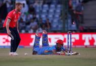 Cricket - England v Afghanistan - World Twenty20 cricket tournament - New Delhi, India, 23/03/2016. Afghanistan's Najibullah Zadran dives successfully to make his crease as England's Ben Stokes looks on. REUTERS/Adnan Abidi