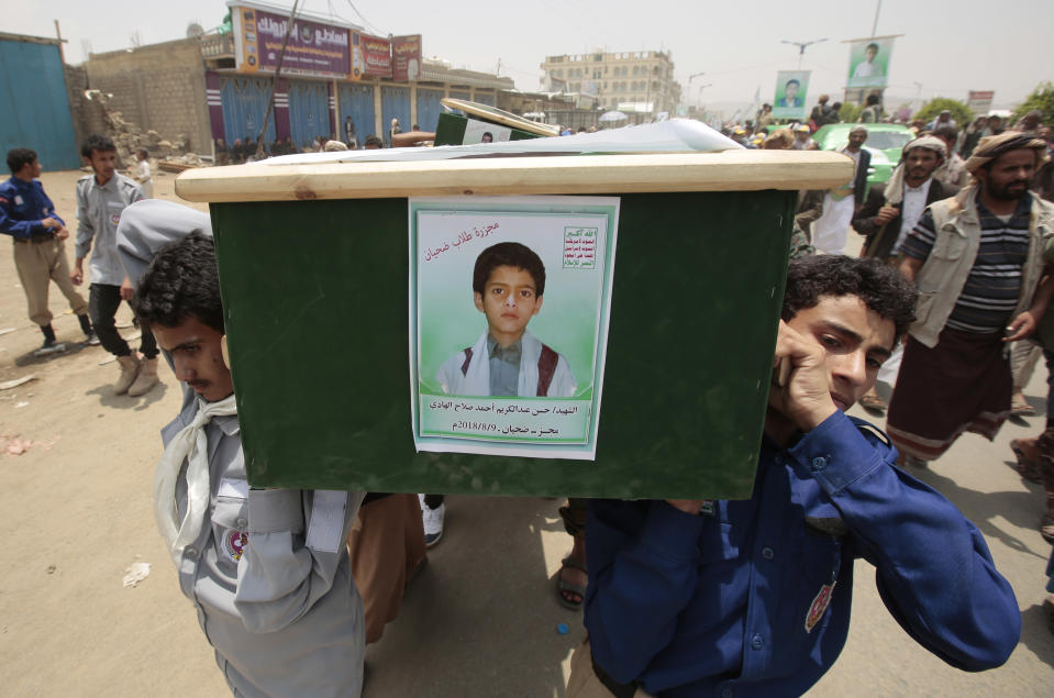 Yemeni people carry the coffin of a boy who was killed by a Saudi-led airstrike, during a funeral in Saada, Yemen, Monday, Aug. 13, 2018. Yemen's shiite rebels are backing a United Nations' call for an investigation into the airstrike in the country's north that killed dozens of people including many children. (AP Photo/Hani Mohammed)