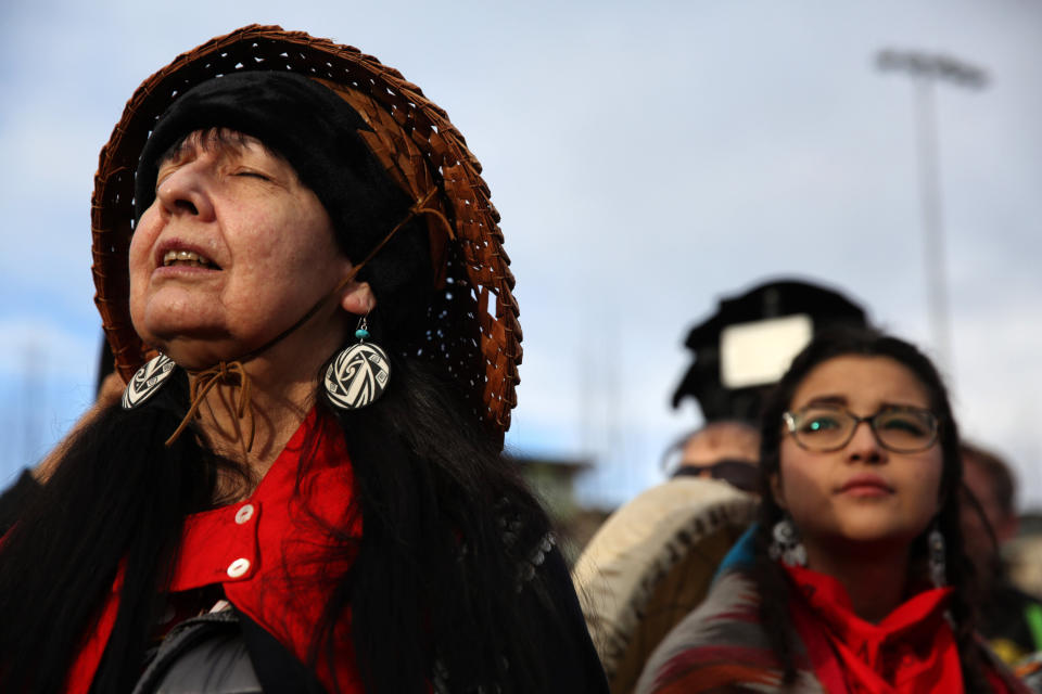 Ellany Kayce of Tlingit Nation closes her eyes and listens to a song performed by members of the Native community before thousands march through the streets of Seattle. The march was led by families of missing or murdered indigenous women. (Photo: Photo by GENNA MARTIN/San Francisco Chronicle via Getty Images)