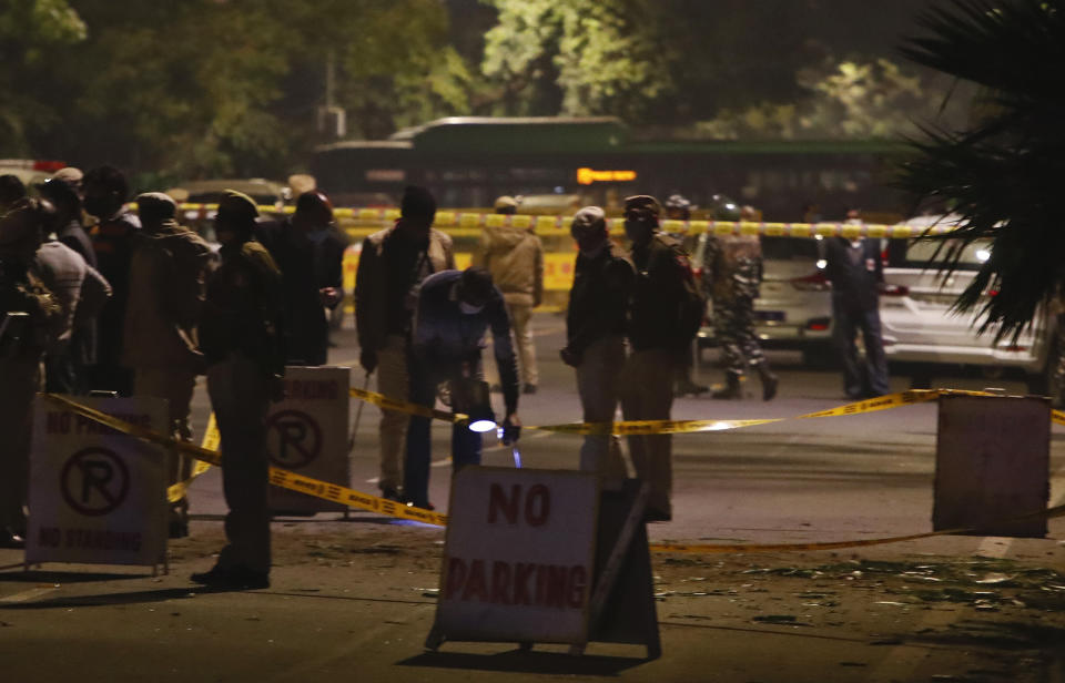 Policemen stand guard near the Israeli Embassy after a blast in the area in New Delhi, India, Friday, Jan. 29, 2021. A "very low intensity" device exploded Friday near the Israeli Embassy in the Indian capital, but there were no injuries and little damage, police said. (AP Photo/Manish Swarup)