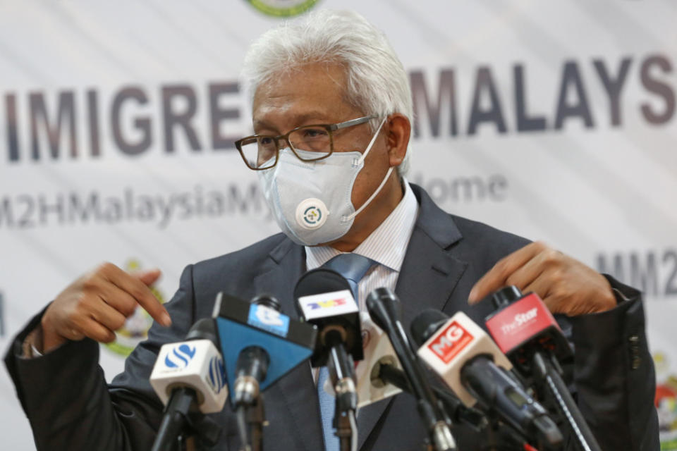 Home Minister Datuk Seri Hamzah Zainudin speaks during a press conference at the Malaysian Immigration Department headquarters in Putrajaya, January 21, 2022. — Picture by Yusof Mat Isa