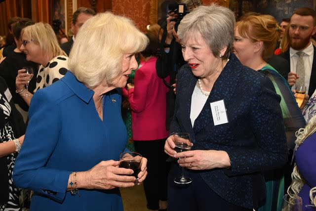 <p>Eamonn M. McCormack - Pool/Getty</p> Queen Camilla and former Prime Minister Theresa May chat at the Buckingham Palace reception on May 1, 2024.