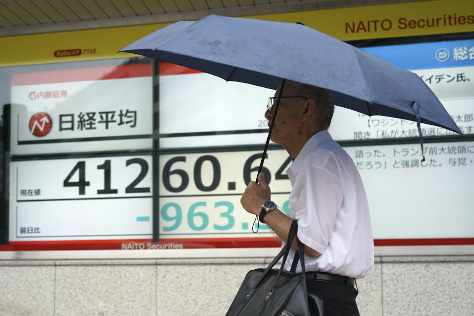 A person walks in front of an electronic stock board showing Japan's Nikkei index at a securities firm Friday, July 12, 2024, in Tokyo. (AP Photo/Eugene Hoshiko)