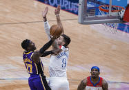 Los Angeles Lakers guard Dennis Schroder (17) shoots over New Orleans Pelicans center Willy Hernangomez (9) in the first quarter of an NBA basketball game in New Orleans, Sunday, May 16, 2021. (AP Photo/Derick Hingle)