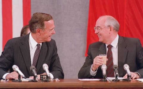  US President George Bush (L) and Soviet counterpart Mikhail Gorbachev laugh during their joint press conference 31 July 1991 in Moscow concluding the two-day US-Soviet Summit dedicated to the disarmament - Credit: AFP