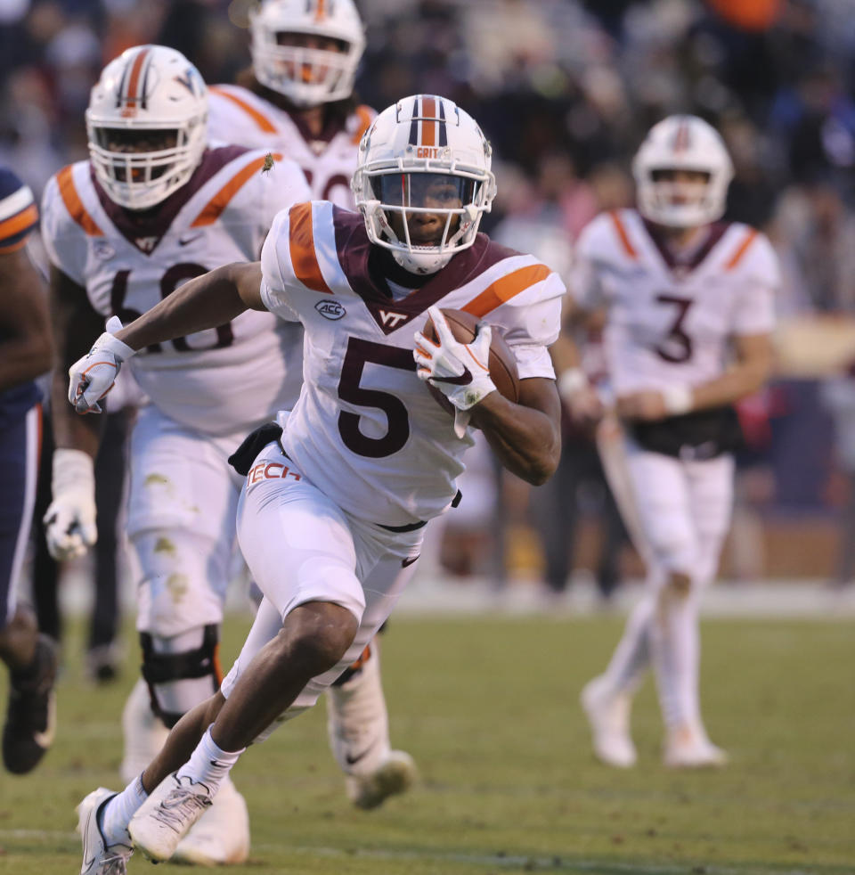 Virginia Tech running back Raheem Blackshear (5) runs for a touchdown in the first half of an NCAA college football game in Charlottesville, Va. Saturday Nov. 27 2021. (Matt Gentry/The Roanoke Times via AP)