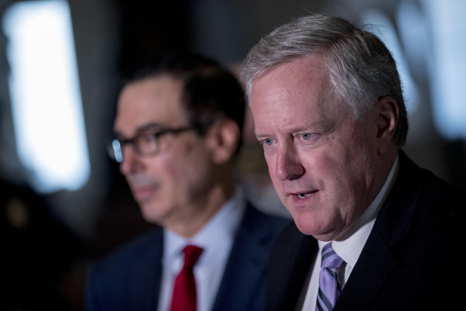 White House Chief of Staff Mark Meadows, right, accompanied by Treasury Secretary Steven Mnuchin, left, speaks to reporters following a meeting with House Speaker Nancy Pelosi of Calif. and Senate Minority Leader Sen. Chuck Schumer of N.Y. as they continue to negotiate a coronavirus relief package on Capitol Hill in Washington, Friday, Aug. 7, 2020. (AP Photo/Andrew Harnik)