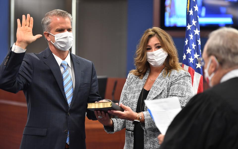 Judge Lee Haworth swears in Brennan Asplen, left, as 
Sarasota County superintendent of schools, on Aug. 10, 2020. His wife, Mari Ellen Asplen, is by his side. Asplen was forced out by a new School Board in December 2022.