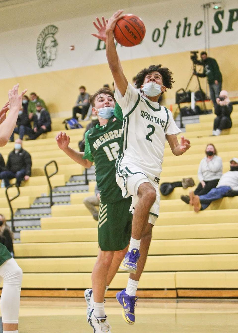 Oakmont's J.J. Hicks (2) drives to the basket in front of Nashoba's Niklas Pavia  during Tuesday's game in Ashburnham.